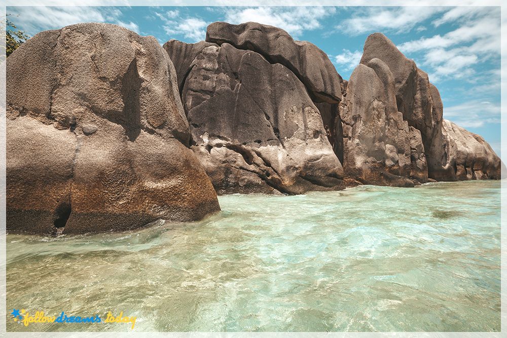 Beautiful clear blue green water among shore rocks - Seychelles island